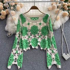 Embrace the art of crochet with this handcrafted green and cream crochet top. This unique piece features intricate floral patterns, meticulously crafted with a blend of green and cream yarns. The open-knit design adds a bohemian touch, perfect for layering over camisoles or bralettes for a chic, laid-back look. The wide, bell sleeves enhance the vintage appeal, making this top a standout addition to your wardrobe.The tops relaxed fit and breathable fabric ensure comfort and versatility, suitable Spring Bohemian Crochet Open Knit Dress, Green Open Knit Top For Summer, Bohemian Lace Crochet Top With Open Knit, Green Bohemian Crochet Dress For The Beach, Green Bohemian Crochet Dress For Beach, Casual Green Crochet Top With Open Knit, Green Long Sleeve Crochet Top For Beach, Spring Green Crochet Lace Dress, Casual Green Open Knit Crochet Top