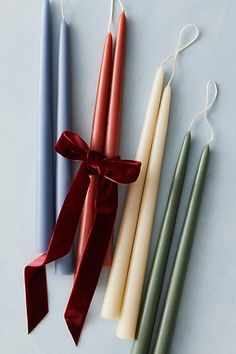 three candles tied with ribbon and sitting next to each other