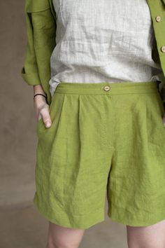 "Smart shorts being cut from lightweight, they work so well for balmy outside days. The shorts are designed to have a high-rise waist and pleats along the front that enhance the loose, breezy fit. Surely the garment is tailored with in-seam pockets that are an indispensable element of any practical apparel. The waistband is equipped with a shirr to better fit in shape. Such an up-to-date classic cut looks splendid with tops optionally covered with a jacket or you can create an astonishing combin Green Wide Leg Shorts With Pockets, Green Wide-leg Shorts With Pockets, Green Relaxed Fit Wide Leg Shorts, Green Relaxed Fit Bermuda Shorts, Green Bermuda Shorts With Pockets, Green Bermuda Shorts With Relaxed Fit, Green Shorts With Pockets, Green Bermuda Shorts With Elastic Waistband, Green Linen Shorts With Pockets