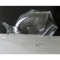 a glass fish figurine sitting on top of a table