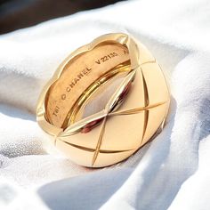 About This Piece: Indulge in the epitome of sophistication with the Authentic! Chanel 18k Yellow Gold Large Wide Coco Crush Band Ring. This luxurious piece showcases Chanel's signature Coco Crush motif, exquisitely crafted in lustrous 18k yellow gold. A statement of elegance and timeless style, it embodies the essence of Chanel's iconic allure. Metal: 18k Yellow Gold Measurements: Size:61, 9.75Width: 11.5mm Weight: 13.3g Hallmarks: T61 Chanel V22135 Au750 French Hallmarks 3187odme Luxury Jewelry Rings Gold, Chanel Ring Gold, Luxury Rings With Polished Finish, Luxury Dome Ring With Diamond Cut For Formal Occasion, Luxury Dome Ring With Diamond Cut For Formal Events, Luxury Formal Dome Ring With Diamond Cut, Luxury Polished Yellow Gold Dome Ring, Designer Everyday Luxury Yellow Gold Rings, Luxury Wide Band Gold Jewelry