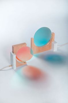 a table lamp that is on top of a wooden stand with two different colored lights