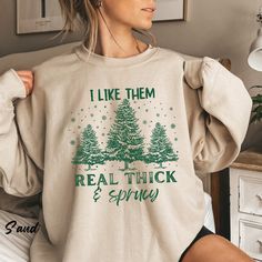 "I like them real thick and sprucy, Women's Christmas gift, funny Christmas gift, holiday shirts, Christmas Sweatshirt, Retro Christmas Shirt Ideal for any situation, a unisex heavy blend crewneck sweatshirt is pure comfort. These garments are made from polyester and cotton. This combination helps designs come out looking fresh and beautiful. The collar is ribbed knit, so it retains its shape even after washing. There are no itchy side seams on these sweaters.  .: Made with a medium-heavy fabric blend of 50% cotton and 50% polyester (8.0 oz/yd² (271.25 g/m this sweatshirt feels cozy and is the perfect choice for those colder months. .: The classic fit along with the crew neckline deliver a comfy wearing experience with a clean-cut style. Meanwhile, the double-needle stitching at the should Funny Winter Top With Text, Winter Funny Style Top With Text, Winter Funny Text Top, Funny Cotton Tops For Winter, Winter Cotton Tops With Funny Text, Winter Tops With Funny Print, Retro Christmas Shirt, Cute Christmas Shirts, Funny Christmas Gifts