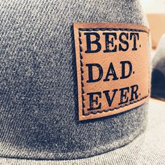 "Best Dad Ever Snapback hat with faux leather patch and thick stitch for added durability and style! You know he's the BEST, so why not show him with one of his favorite things- a hat! Snapback Hats that Dads are sure to LOVE! Show the Dad in your life how much he means to you with these awesome hats! These are stylish and durable to hold up to the Dad life! Adjustable Snapback style. *Richardson 112 style available upon request and made to order so turn around time for that style is about 5-7da Dad Pregnancy Announcement, Black Trucker Hat, Pregnancy Announcement Gifts, Best Dad Ever, Dad Life, New Dads, Black Hat, Kids Hats, Leather Patches