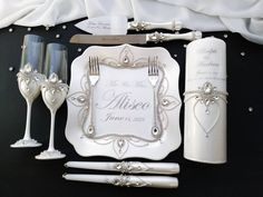 a table setting with silverware and white napkins