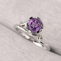 ◆ The ring is handcrafted from sterling silver and decorated with a dazzling 7*7 mm amethyst. It is suitable for engagement/anniversary/daily occasion. ◆ Production Description: Main stone Type: Natural Amethyst Main Stone Shape: Round Cut Main Stone Size: 7*7 mm(1.25ct) Side stone: None Metal: 925 Sterling silver - Other options available in the drop down menu ◆ Customization: √Free for Add Engraving √Other Metal Type Available √Other Gemstones & Shapes Available √Personalization Requests Avail Sterling Silver Amethyst Ring With Accent Stones, Elegant Purple Birthstone Ring With Center Stone, Elegant Amethyst Birthstone Ring In Round Band, Elegant Amethyst Birthstone Ring With Round Stone, Elegant Amethyst Birthstone Ring Round Band, Elegant Amethyst Ring With Halo Setting, Elegant Amethyst Crystal Ring With Center Stone, Elegant Amethyst Ring For A Gift, Elegant Amethyst Birthstone Crystal Ring