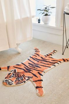 an image of a tiger rug on the floor in front of a window with curtains