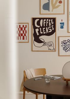 a table with chairs and pictures on the wall