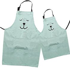 two aprons with faces drawn on them