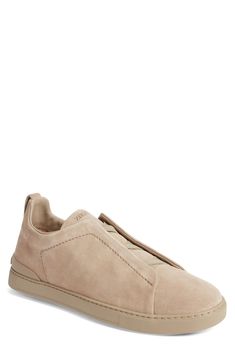 This soft and supple suede sneaker slips on easily with crisscrossed elastic at the vamp and is set on a tonal rubber cupsole for a casual aesthetic. Pull-on style Leather upper and lining/synthetic sole Made in Italy Designer Shoes Suede Slip-on Low-top Sneakers, Suede Low-top Slip-ons With Rubber Sole, Low-top Suede Slip-ons With Rubber Sole, Comfortable Suede Sneakers With Stitched Sole, Suede Low-top Slip-ons With Contrast Sole, Low-top Suede Slip-ons With Contrast Sole, Suede Slip-on Sneakers With Rubber Sole, Low-top Suede Slip-on Sneakers With Branded Insole, Sporty Suede Low-top Slip-ons