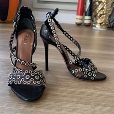 - Designer = Alaia Paris - Size =6.5m(36.5). Trunk 57 - Msrp = $1370 - Alaia Paris Perforated Leather 6.5m Made In Italy Open Toe Strappy Sandals - Heel Height = 4.25” Inches (10.5cm) - Metal Studded Black Leather - Measured On The Inside From Front Tip Of Open Toe To Back Tip Of Heel To Give An Estimate Of Size Length = Approximately 24cm -: This Is Mannequin Display Item. Never Worn. Only Tried On In The Store By Customers. - Genuine And Authentic Or Your Money Back Trunk 57 Luxury High Heel Sandals With Studded Outsoles, Evening Sandals With Studded Rubber Outsoles And Open Heel, Designer Heels With Ankle Strap And Studded Outsoles, Evening Open Toe Studded Sandals, Elegant Ankle Strap Heels With Studded Rubber Outsoles, Elegant Heels With Round Toe And Perforations, Elegant Round Toe Heels With Perforations, Elegant Heels With Perforations, Formal Ankle Strap Sandals With Studded Rubber Outsoles