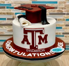 a cake that is decorated to look like a graduation cap and diploma on top of it