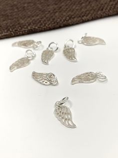 925 Sterling Silver Angel Wing Charm Approx. Size: 18mm x 6mm ( including jump ring) Approx. Inner Jump Ring: 4mm Color: Silver Material: 925 Sterling Silver Quantity: 1pc  Shipping Details: ♥ FREE SHIPPING to Canada via Canada Post for all orders above CA$100. Any orders above CA$50 will have a tracking number as well ♥ FREE SHIPPING to USA for all orders above US$35 via USPS First Class Mail Tracked. CA$8.99 Delivery charges for orders below US$35 ♥ All orders are shipped within 1-2 business d Elegant Sterling Silver Charms For Jewelry Making, Sterling Silver White Gold Charms For Jewelry Making, Silver Pendant Charms For Anniversary, White Gold Sterling Silver Charms For Jewelry Making, Engraved Sterling Silver Charms, Sterling Silver Charms With Lobster Clasp, Silver Charms With Sterling Silver Clasp For Gifts, Silver Round Pendant Charms For Anniversary, Nickel-free White Gold Sterling Silver Charms