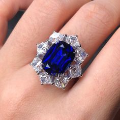 a woman's hand with a blue and white ring on top of her finger