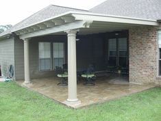 a covered patio with chairs and tables on it