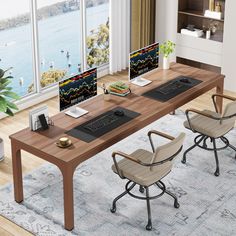 an office desk with two computer monitors on it and chairs in front of the desk