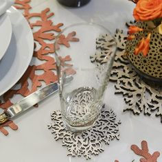 a white table topped with plates and silverware