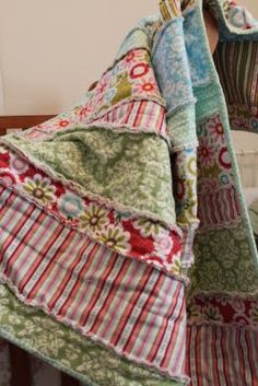 a quilted blanket is draped over a crib