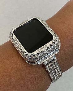 a woman's arm with an apple watch on it and diamonds around the wrist