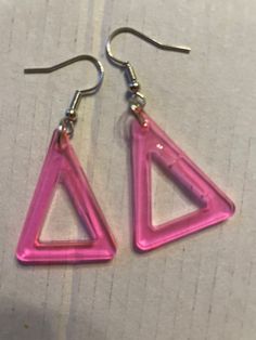 This set of earrings features a medium pink resin halo triangle for each ear.  *Size color and shape subject to look slightly different in person than in picture.* Gift box option available. Bubbling imperfections may be present from the curring and hardening process but all minor cosmetics that do not take away from the durability and look of the item. Pink Halo, Picture Gifts, Etsy Earrings Dangle, Jewelry Earrings Dangle, To Look, Halo, Dangle Drop Earrings, Dangle Earrings, Gift Box