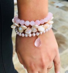 Feminine and so beautiful on the arm, this cluster of three pink pearl and quartz bracelets just become a classic and a favorite from the moment you put them on. Traditional and yet so on trend this season, from the stunning smooth round pearls to the lustrous coin pearls, and down to the gorgeous large pink quartz drop, this is truly the pearl lovers arm candy. I've heard it said that pink is the new black and what could be more true of this piece that will go with practically everything you wear. Try wearing them separately or layer with other bracelets! What a beautiful gift for any occasion!! Pink Stackable Jewelry For Mother's Day, Mother's Day Pink Stackable Jewelry, Elegant Rose Quartz Gemstone Beaded Bracelets, Elegant Rose Quartz Gemstone Beaded Bracelet, Stackable Rose Quartz Jewelry For Gifts, Feminine Pink Rose Quartz Jewelry, Pink Gemstone Bracelets For Gift, Elegant Stackable Rose Quartz Jewelry, Elegant Rose Quartz Bracelet For Gift