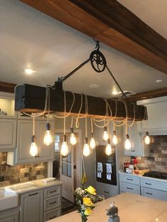 a kitchen with lots of lights hanging from the ceiling