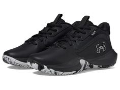 the under armour shoes are black and white