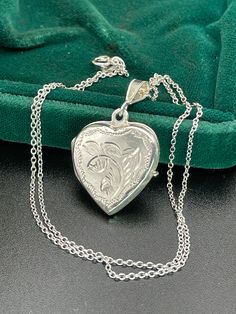 Vintage  silver locket for women. Double sided silver locket with hand engraved back and front. Double photo locket.   Silver heart locket. Silver pendant . Silver necklace for women.       Vintage circa 70s. Condition: necklace in perfect vintage condition. Materials: Silver. Rhodium plated silver chain.  Measure: chain 16"/ 41 cm,   Locket  0.7" x 0.7"/  1.8 x 1.8 cm. Package: gift wrap available, please specify when ordering. Delivery: your order will be send by Royal Mail with tracking and s Stamped 925 Round Pendant Keepsake Jewelry, Hallmarked Medallion Jewelry For Keepsake, Medallion Jewelry Hallmark Keepsake, Engraved Jewelry Collectible For Valentine's Day, Keepsake Medallion Jewelry With Hallmark, Etched Silver Jewelry For Mother's Day, Silver Locket Jewelry For Mother's Day, Mother's Day Silver Locket Jewelry, Antique Engraved Necklaces For Mother's Day