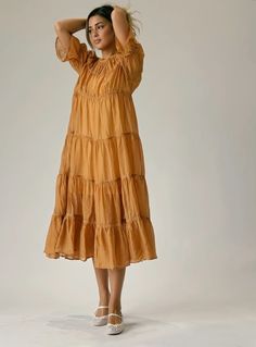 Orange Maxi Dress With Ruffles And Short Sleeves, Bohemian Short Sleeve Flowy Tiered Dress, Modest Tiered Maxi Dress For Summer, Brown Tiered Midi Dress For Summer, Flowy Brown Tiered Dress, Flowy Tiered Brown Dress, Brown Tiered Dress For Vacation, Brown Ruffled Maxi Dress, Flowy Brown Maxi Dress With Ruffles