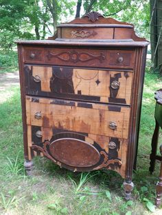 an old wooden dresser sitting in the grass