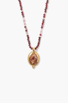 Alternating lengths of fiery gems and crystals create a beautiful ombré pattern in this vibrant beaded necklace with a shimmering gold framed red zebra jasper pendant. 18k sterling silver, red zebra jasper, garnet, strawberry quartz, crystal. 22" in length. Handmade in Vietnam.