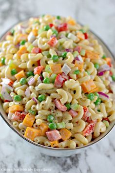 a bowl filled with pasta salad on top of a table