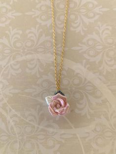 "Stunning and sweet resin rose necklace in soft pink, pearl white and green has iridescent finish.   Pendant measures 3/4\" L X 3/4\" W and is on an 18\" chain. ★ Want to see more?  Please visit my shop at: https://www.etsy.com/shop/DesignsByPeg" Delicate Pink Necklace With Rose Design, Elegant Pink Rose Necklace, Pink Flower Pendant Jewelry With Rose Design, Pink Flower-shaped Necklaces With Roses, Pink Rose Necklaces For Gifts, Rose Flower Necklace With Rose Design, Resin Rose, Saint Marys, Rose Gift