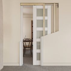 an open door leading to a dining room with a table and chair in the background