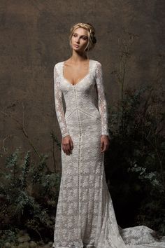 a woman in a white wedding dress posing for a photo