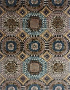 an area rug with many circular designs on the side and blue, brown, beige, and green colors