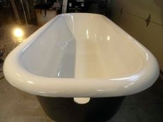 a white bath tub sitting on top of a floor