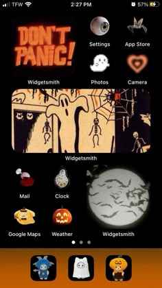 an orange and black cell phone with halloween stickers on the screen, along with other icons