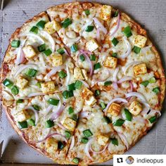 a pizza sitting on top of a pan covered in cheese and veggie toppings