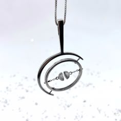 This gyroscope pendant was a collaboration with one of my favorite Instagram accounts, @physicsfun!The pendant spins with floating magnets at the center and is great for fidgety hands and curious souls...The magnets are suspended on silver chain, breaking apart and snapping back together when the magnetic force-field is played with. It is a joy to fidget with ☺︎The bail (where the pendant connects to the chain) is designed to double as a wand to hold onto while spinning the gyroscope. Roll the w Chain Breaking, Moving Jewelry, Kinetic Jewelry, Magnetic Necklace, Diamond Pendent, Metalsmithing Jewelry, Magnetic Jewelry, Pendant Bails, Ancient Jewelry