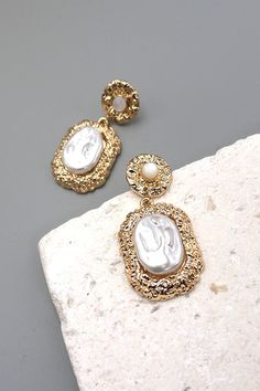 These earrings would make a great statement piece! They feature a beautiful hammered classic shape with large pearl drop earrings! This will look perfect with puff hem dress, shorts, rompers or maxi dress.DIMENSION length: 1.75"width: .75" earring back: Postmetal finish: Matte Gold Platingproduct: Lead & Nickel Compliantanti-tarnish: Double E-coating Post Metal, Dress Shorts, Wall Accessories, Stylish Earring, Pearl Drop Earrings, Pearl Drop, Hem Dress, Matte Gold, Earring Backs