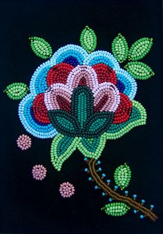 a beaded flower on a black background with beads and flowers in the bottom corner