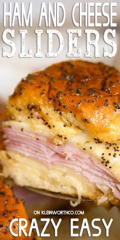 ham and cheese sliders on a plate with text overlay that reads poppy seed ham and cheese sliders