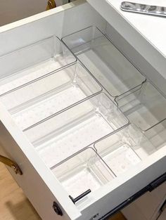 an open drawer on the side of a kitchen counter