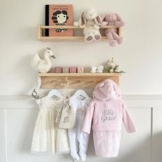 two wooden shelves holding stuffed animals and other items on top of them in a baby's room