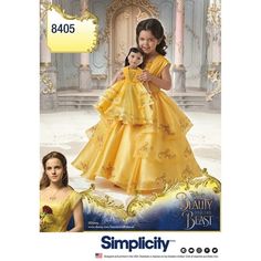 the doll is wearing a yellow dress with princesses on it's chest and head