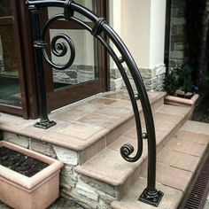 a set of stairs leading up to a building with stone steps and planters on each side