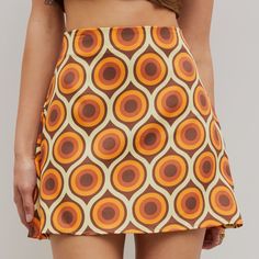 Brown And Orange Circular Retro Pattern Mini Skirt Never Worn Fitted Retro Skirt For Vacation, Retro Fitted Skirt For Vacation, Retro Fitted Skirt For Day Out, Retro Fitted Skirt For The Beach, Retro Mini Skort For Day Out, Retro Mini Length Skort, Retro Fitted Mini Skirt For Summer, High Waist Retro Skort For Spring, Retro Summer Skort For Day Out