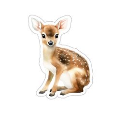 a small deer sticker sitting on top of a white surface next to a wall