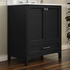 a bathroom with a sink and black cabinet